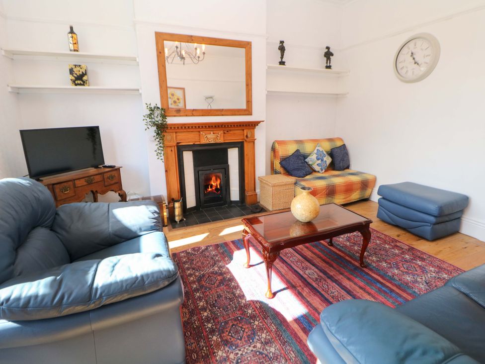 A living room with a sofa and fireplace at Glenside Lodge in Chapel-En-Le-Frith