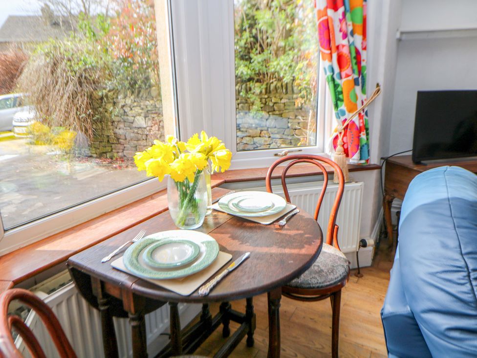 A dining area with a table set for two at Glenside Lodge in Chapel-En-Le-Frith