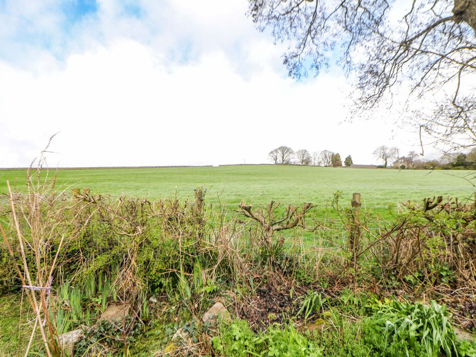 An outdoor area with a grassy field and a fence at Glenside Lodge in Chapel-En-Le-Frith