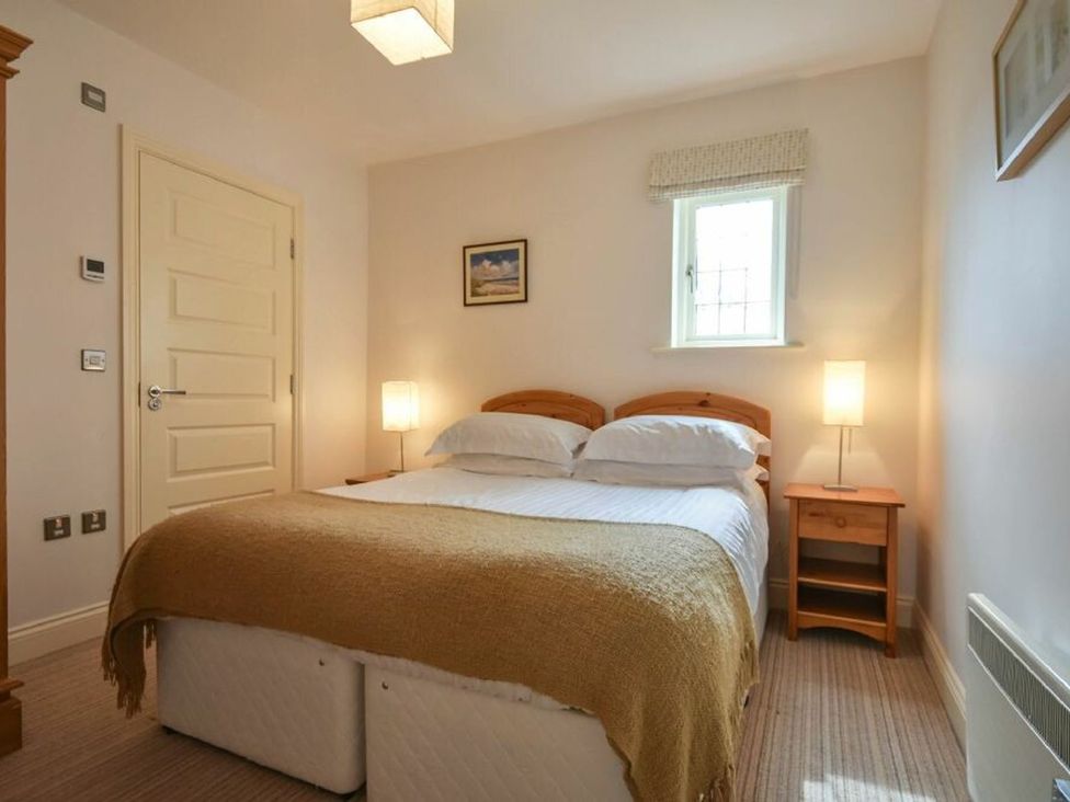 A bedroom with a bed and bedside lamps at Northrawe in Bamburgh