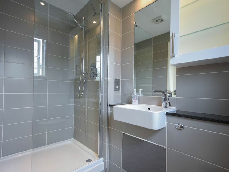 A bathroom with a shower and sink at Northrawe in Bamburgh