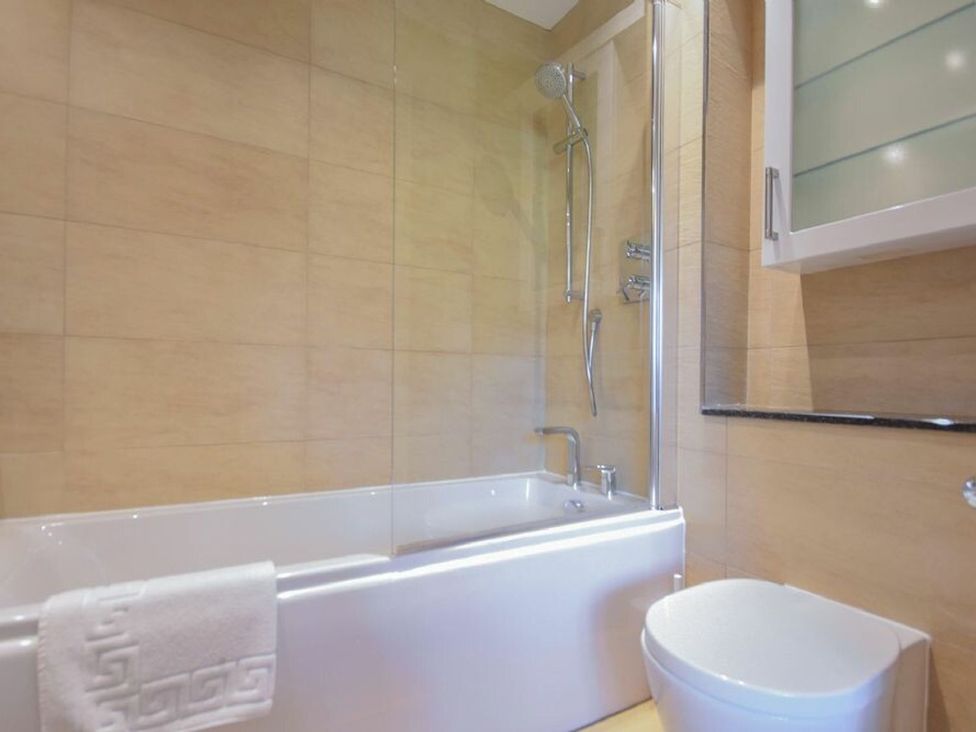 A bathroom with a shower and bathtub at Northrawe in Bamburgh