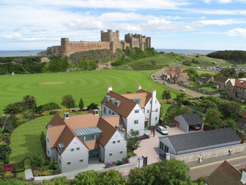 An aerial view of a castle and houses at Northrawe in Bamburgh
