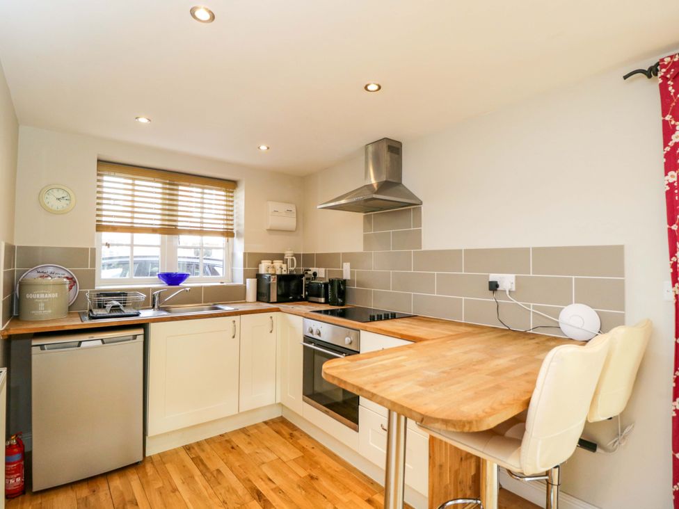 A kitchen with appliances and countertop at The Barn at Myrtle Cottage