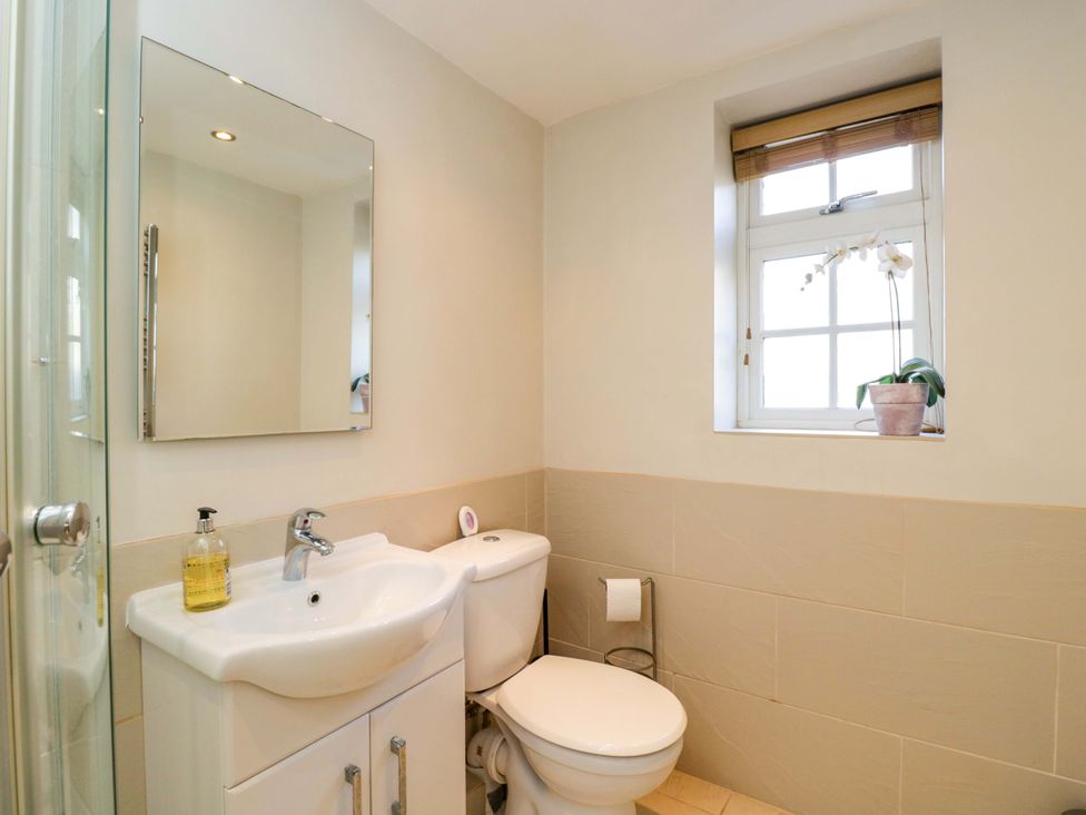 A bathroom with a sink and toilet at The Barn at Myrtle Cottage