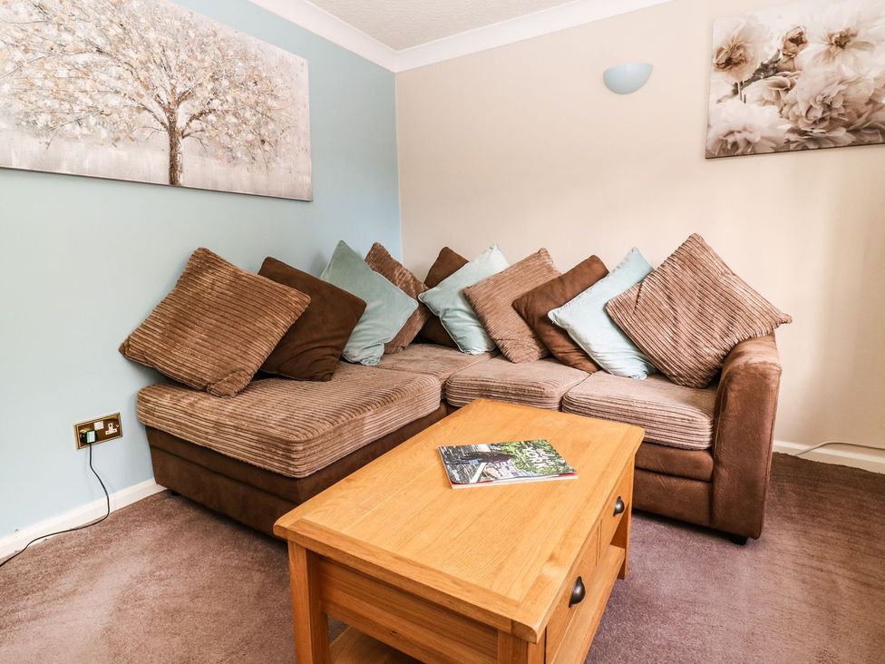 A living room with a sofa and a coffee table at Blacksmiths Retreat in York