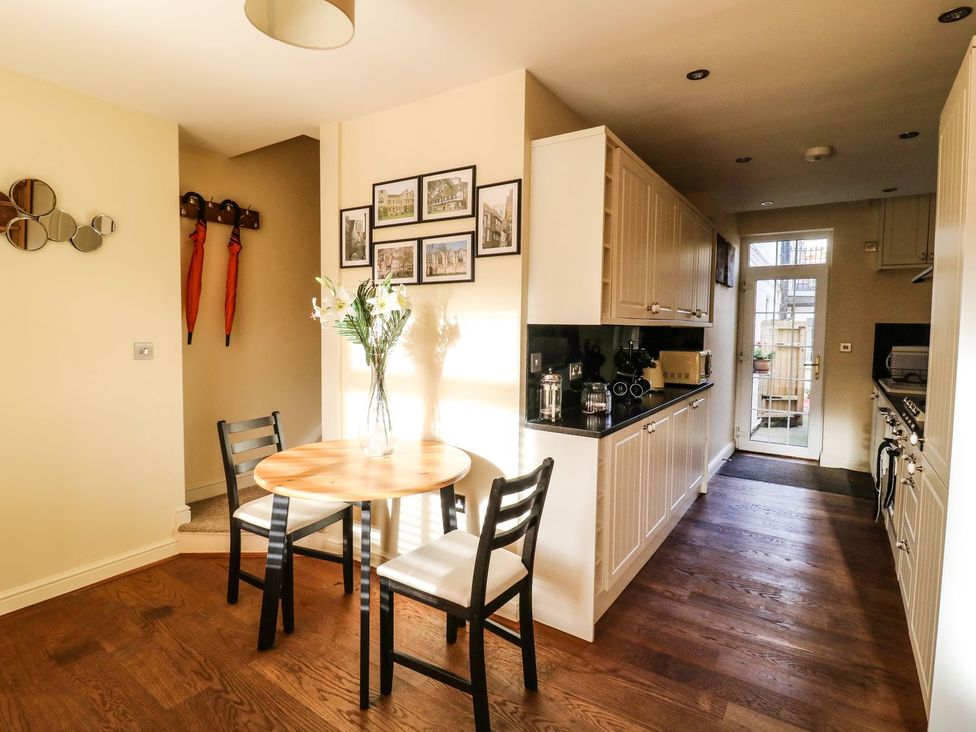 A kitchen with a dining table and chairs at Blacksmiths Retreat in York