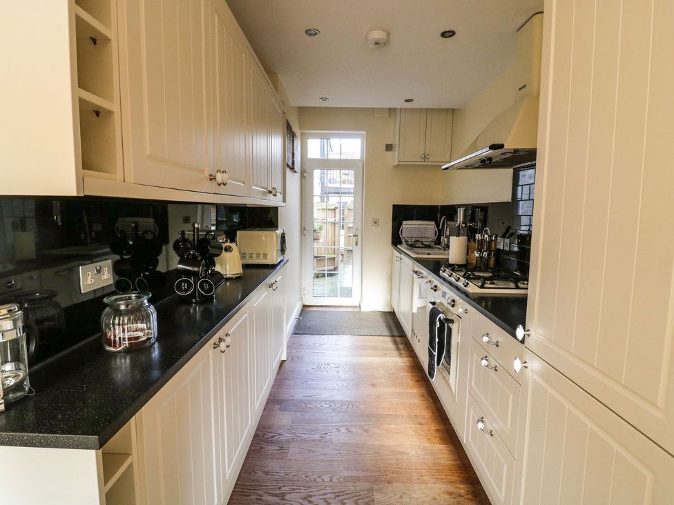 A kitchen with cabinetry and appliances at Blacksmiths Retreat in York