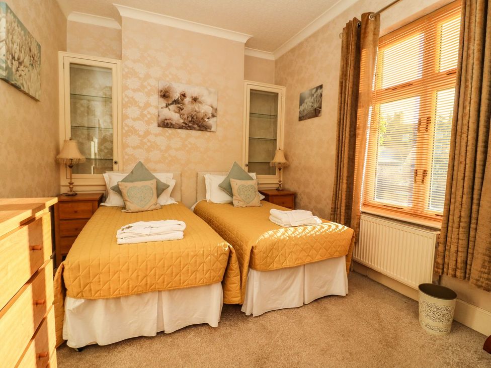 A bedroom with two beds and a dressing table at Blacksmiths Retreat in York