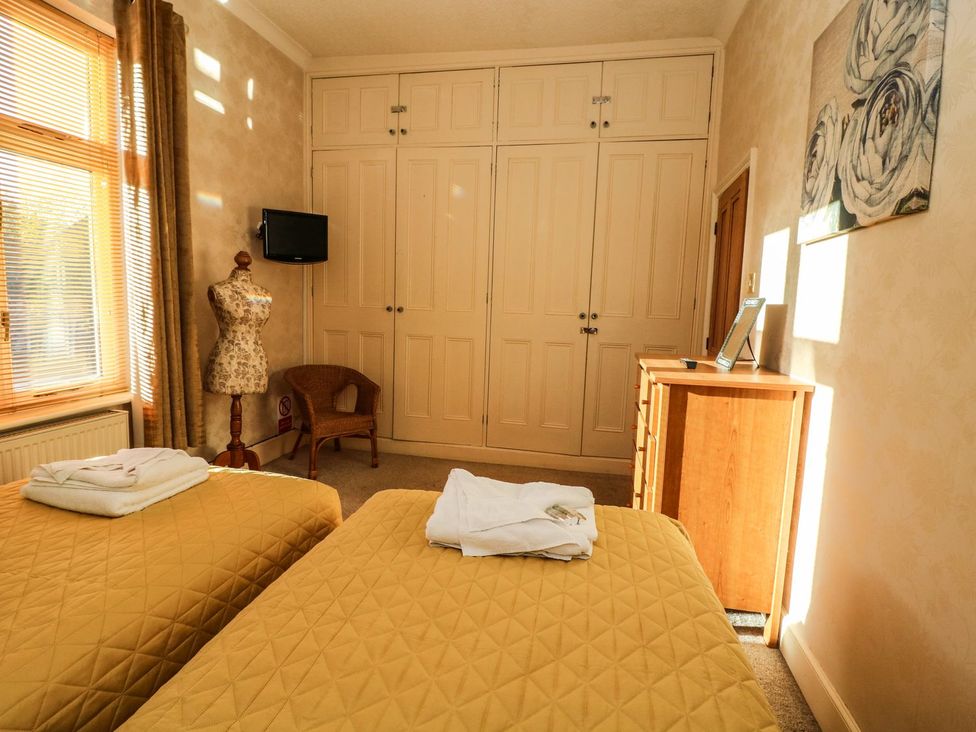A bedroom with two beds and a wardrobe at Blacksmiths Retreat in York