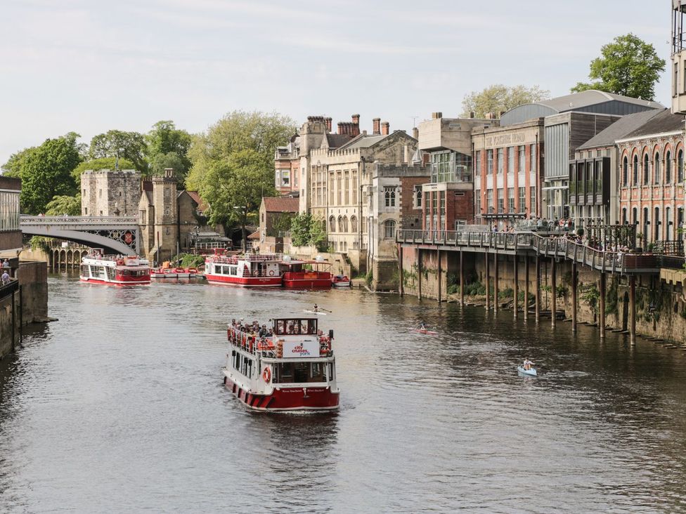 A view of a river with boats and buildings at Blacksmiths Retreat in York