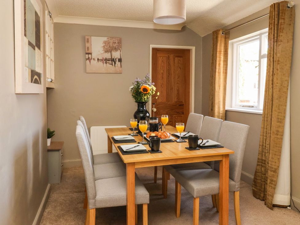 A dining room with a table set for breakfast at Blacksmith Mews, York