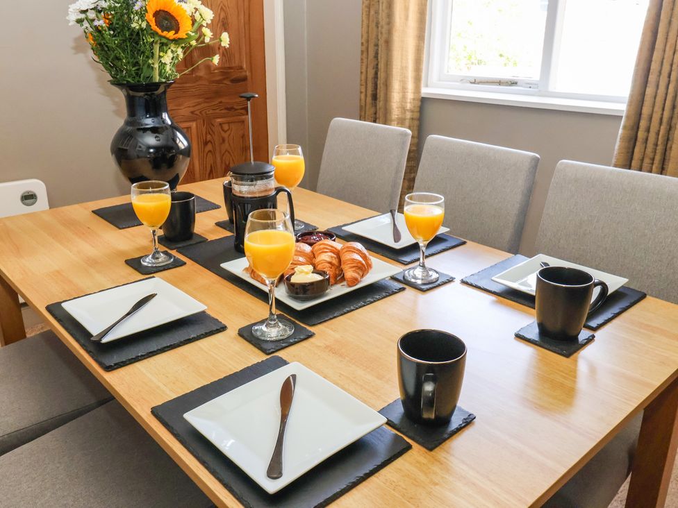 A dining table set with orange juice and pastries at Blacksmith Mews York