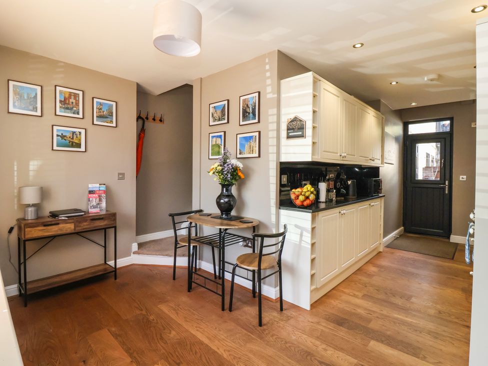A kitchen with a table and chairs at Blacksmith Mews, York