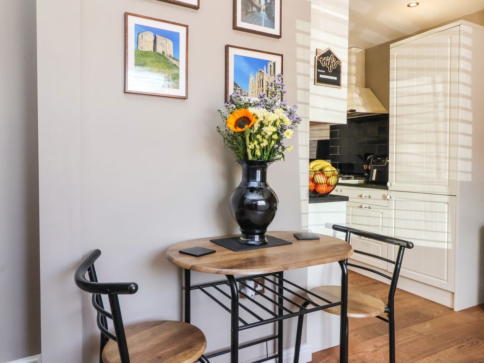 A dining room with a table and chairs at Blacksmith Mews, York