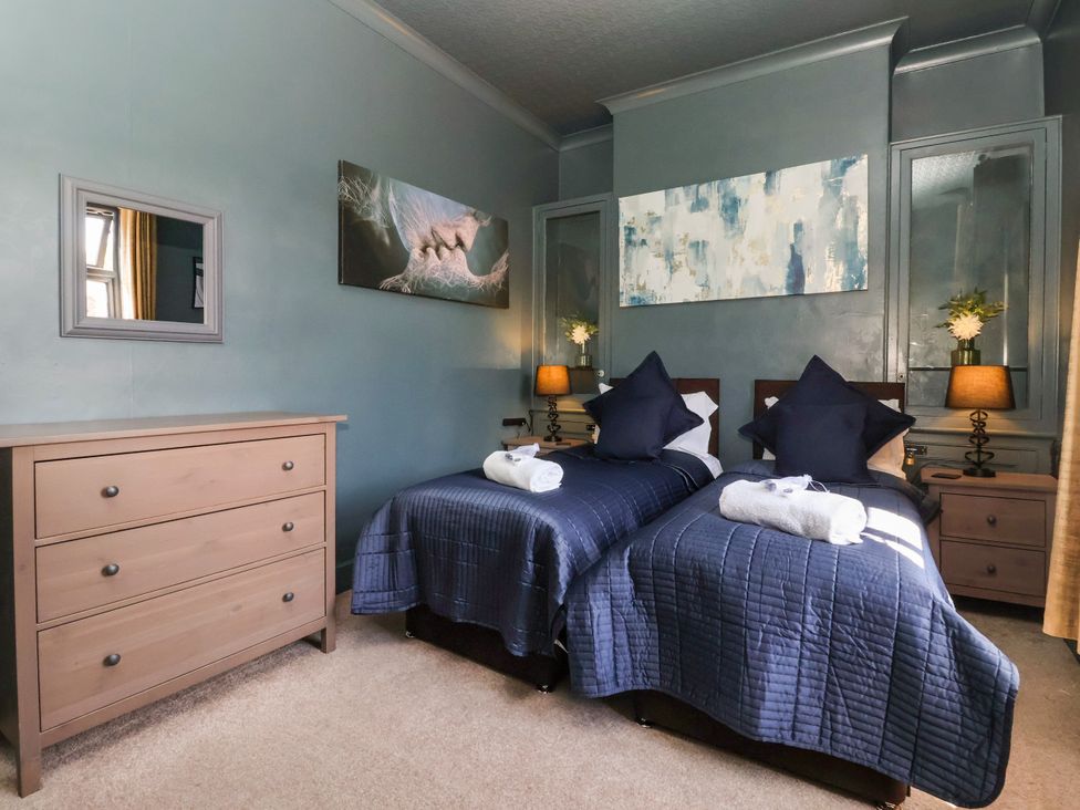 A bedroom with two beds and a dresser at Blacksmith Mews in York