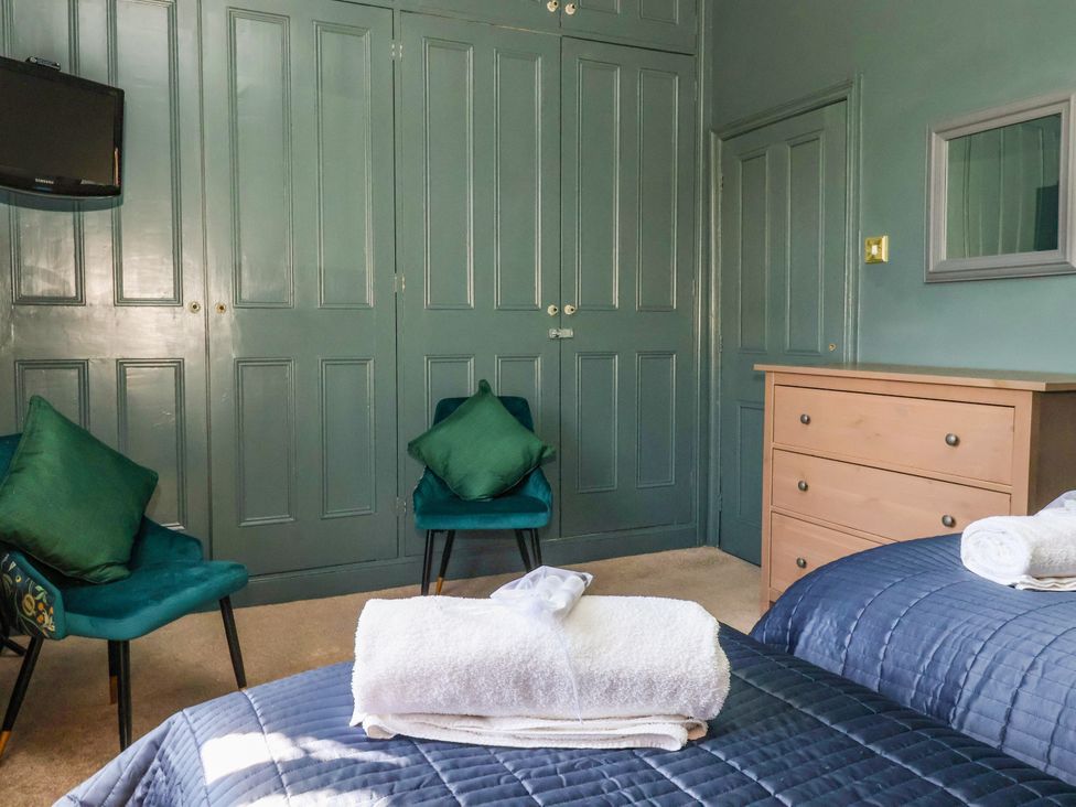 A bedroom with a bed and television at Blacksmith Mews in York