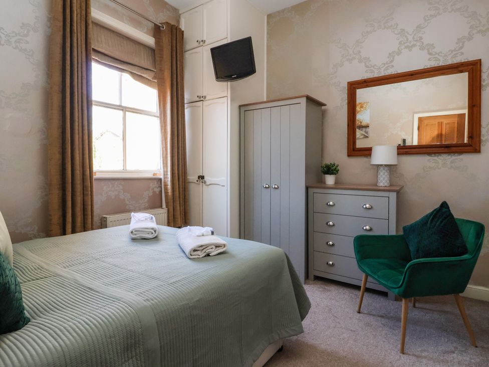 A bedroom with a bed and wardrobe at Blacksmith Mews York