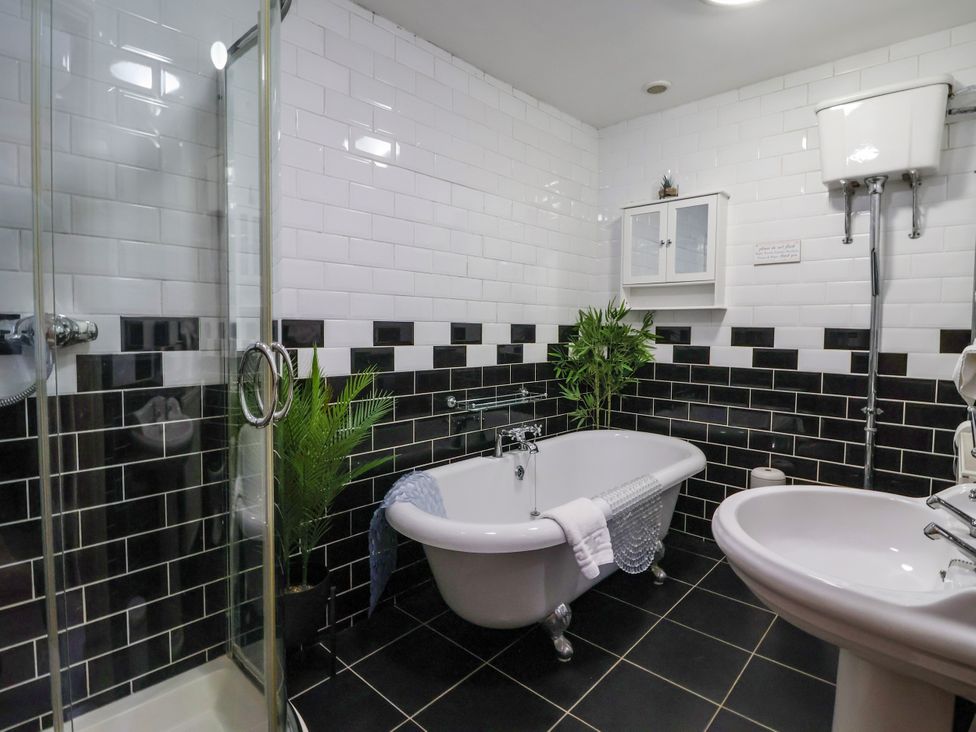 A bathroom with a bathtub, shower, and sink at Blacksmith Mews in York