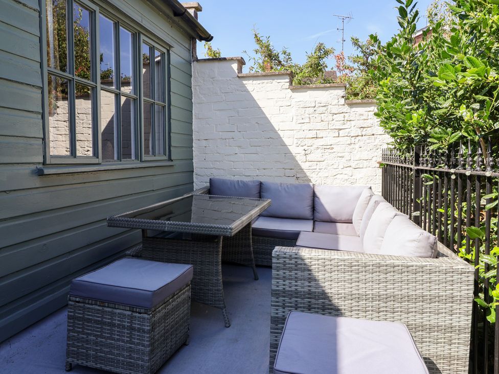 An outdoor seating area with a table and sofa at Blacksmith Mews, York