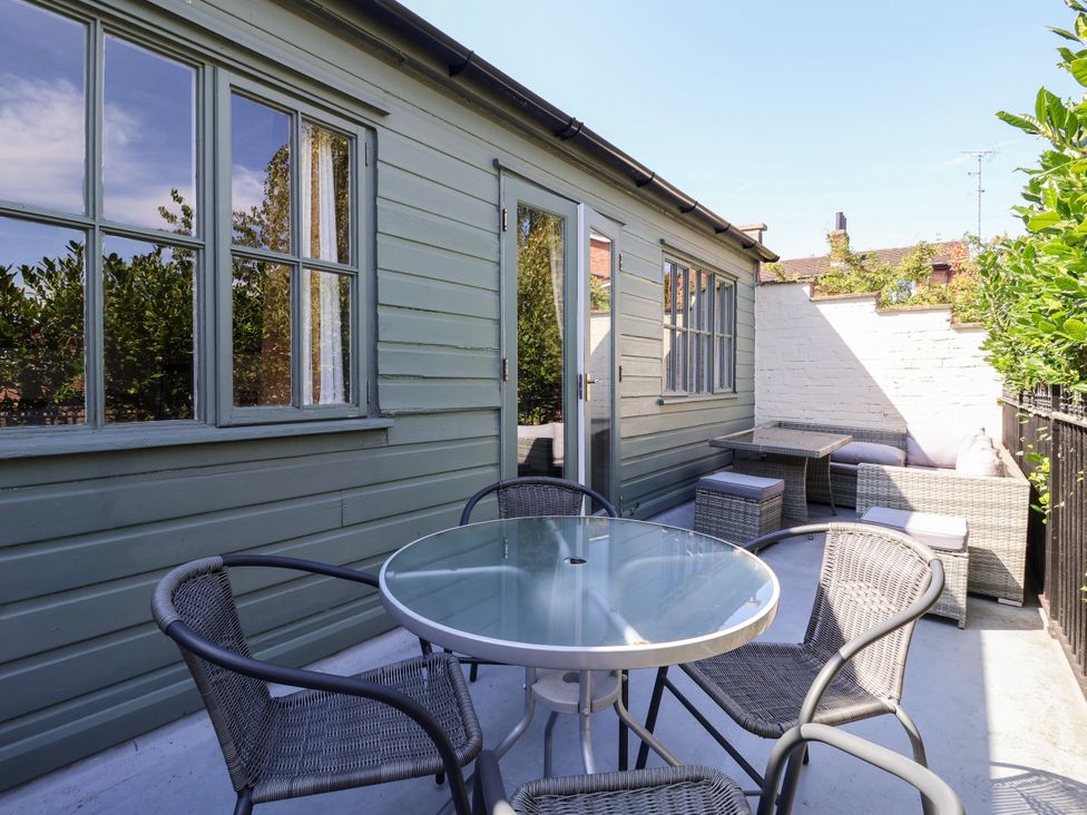 An outdoor seating area with a table and chairs at Blacksmith Mews in York