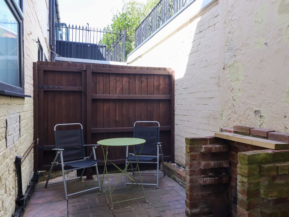 An outdoor area with chairs and a table at Blacksmith Mews in York
