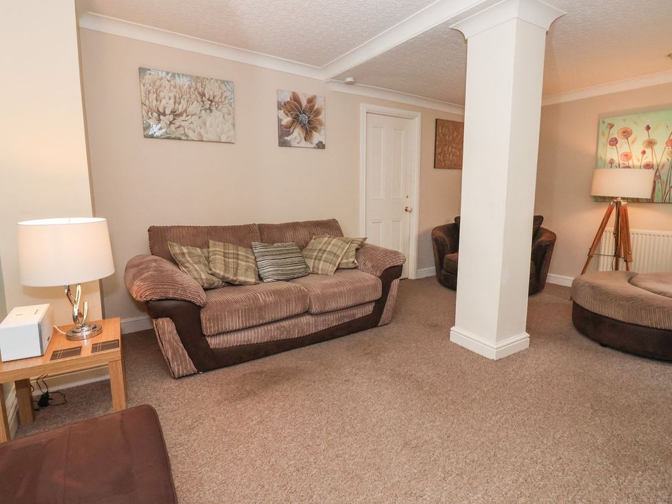 A living room with a sofa and armchairs at Blacksmiths Mews in York