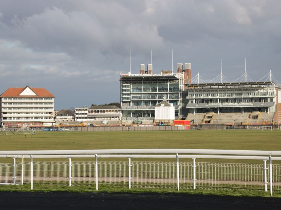 A racecourse with grandstands and a fence at Blacksmiths Mews, York
