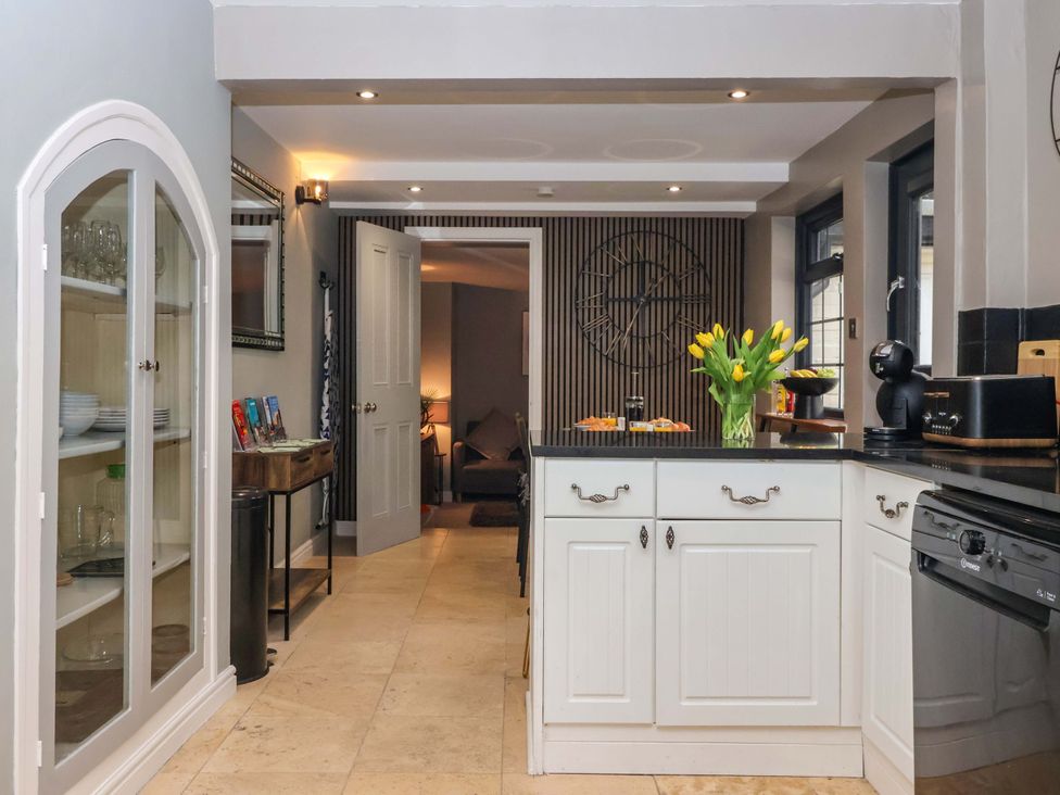 A kitchen with an island and a vase of tulips at Blacksmiths Retreat in York