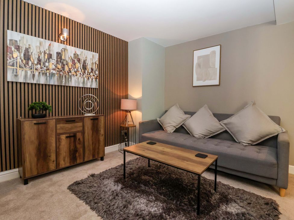 A living room with a sofa and coffee table at Blacksmiths Retreat, York