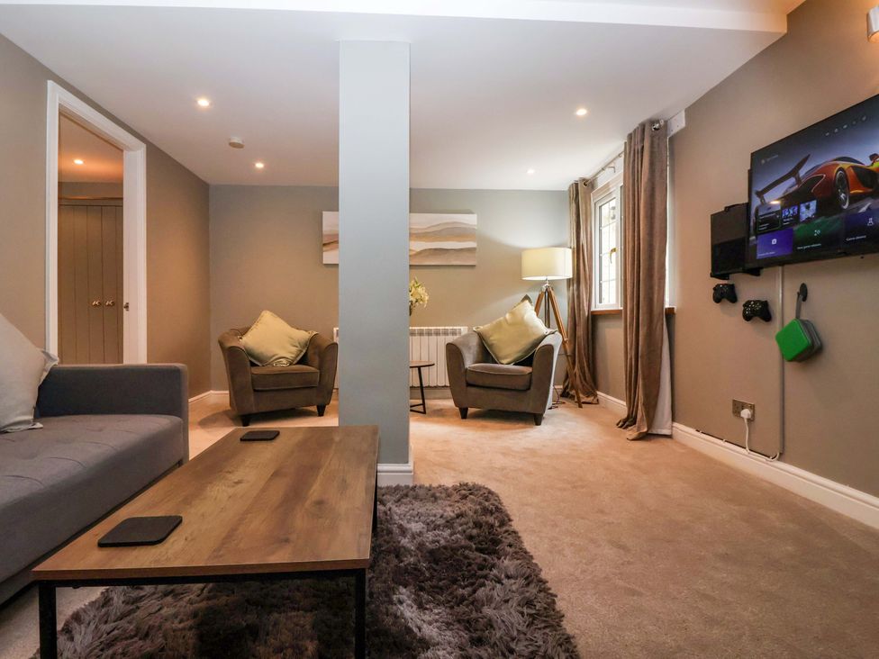 A living room with seating and a television at Blacksmiths Retreat in York