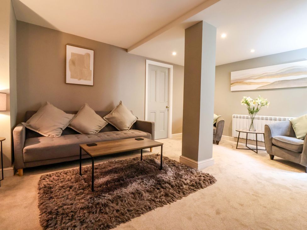 A living room with a sofa and coffee table at Blacksmiths Retreat in York