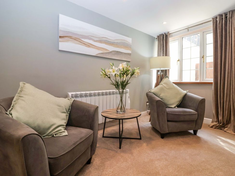 A living room with armchairs and a coffee table at Blacksmiths Retreat in York