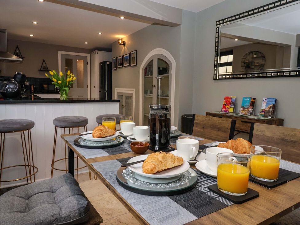 A kitchen with a dining table set for breakfast at Blacksmiths Retreat in York