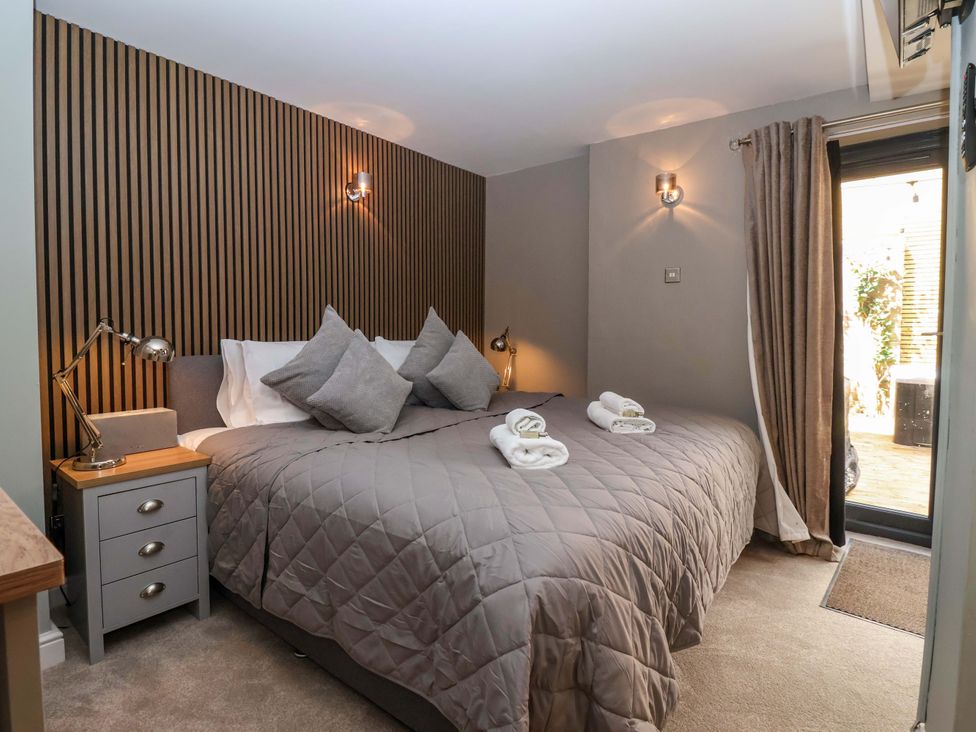 A bedroom with a bed and bedside table at Blacksmiths Retreat in York
