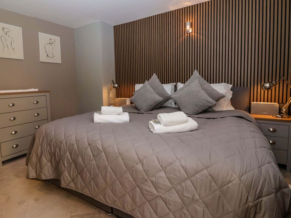 A bedroom with a double bed and decorative art at Blacksmiths Retreat in York