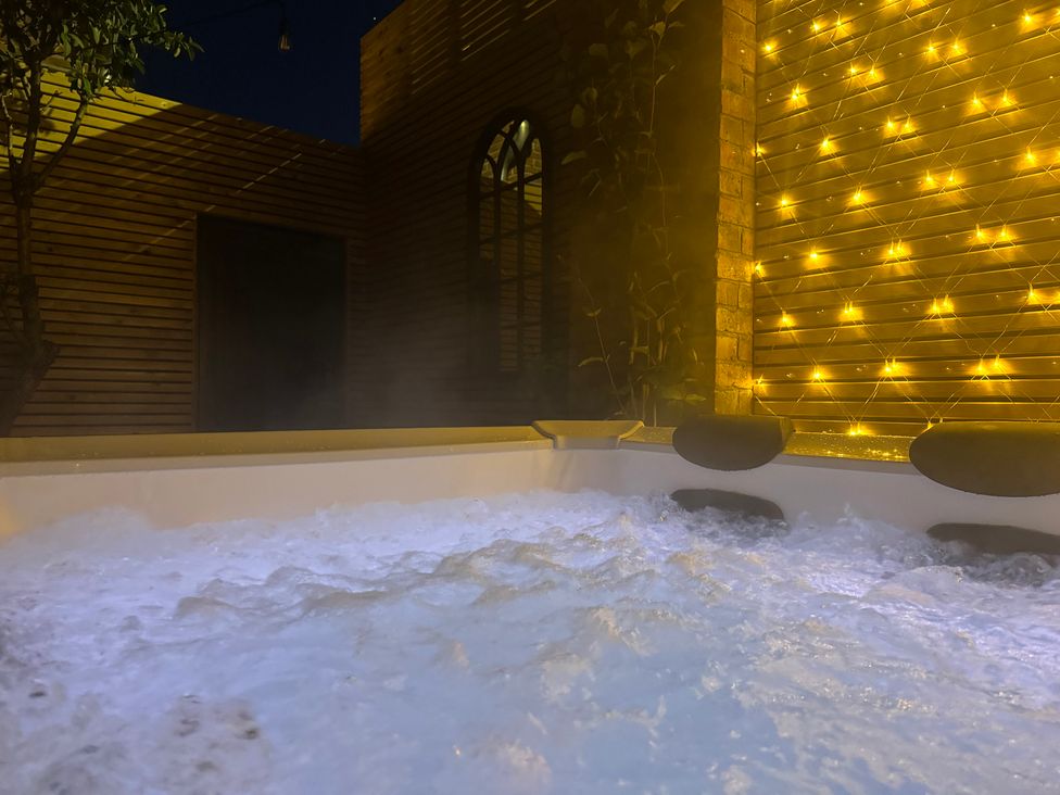 A hot tub with water and fairy lights at Blacksmiths Retreat in York