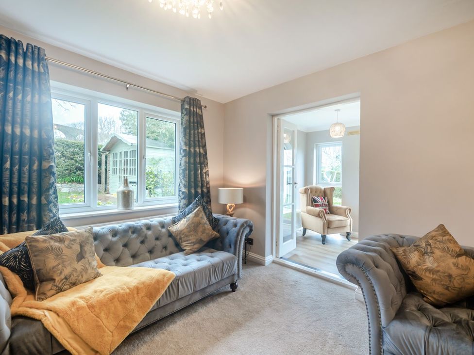 A living room with sofas and a view at Broadsands in Paignton