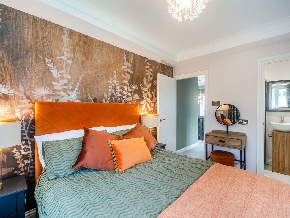 A bedroom with a bed and nightstand at Broadsands in Paignton