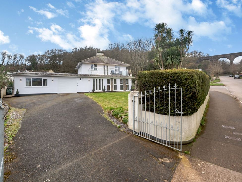 A house with a garage and driveway at Broadsands in Paignton
