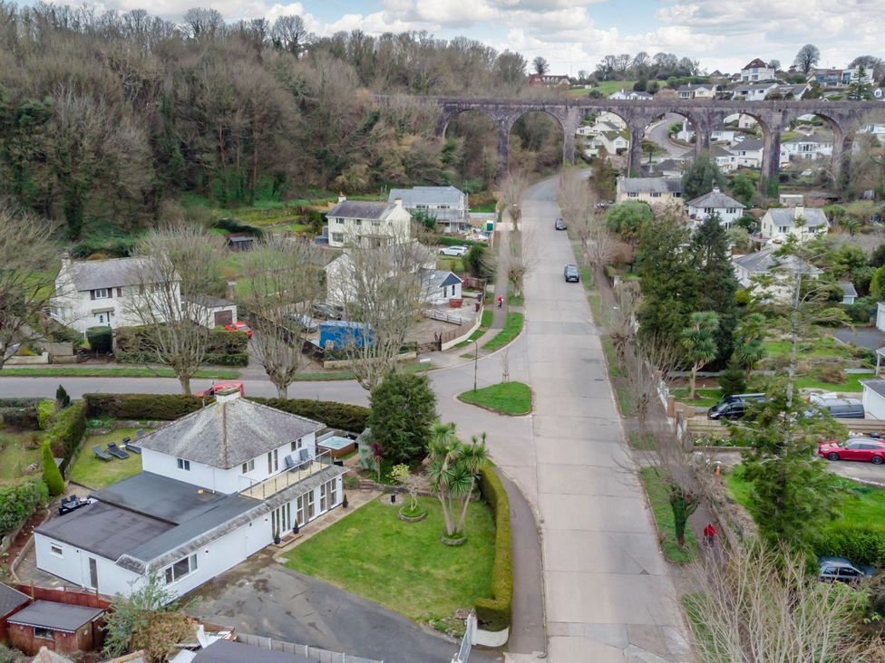 An aerial view of houses and a road near a viaduct at Broadsands in Paignton