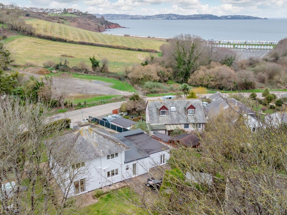 A view of houses and land near the ocean at Broadsands in Paignton
