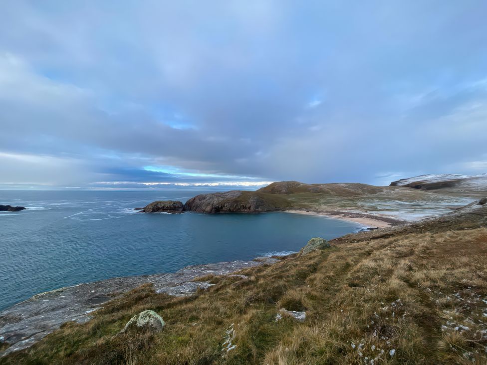 A coastal view with sea and beach at An Grianan in Lairg