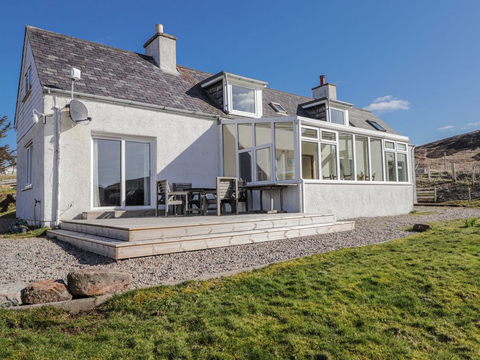 A house with a deck and chairs at An Grianan in Kinlochbervie
