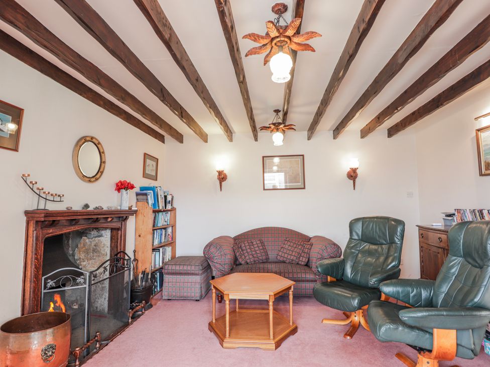 A living room with a sofa and coffee table at An Grianan in Kinlochbervie