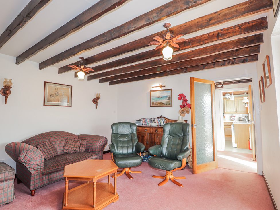 A living room with a sofa and armchairs at An Grianan in Kinlochbervie