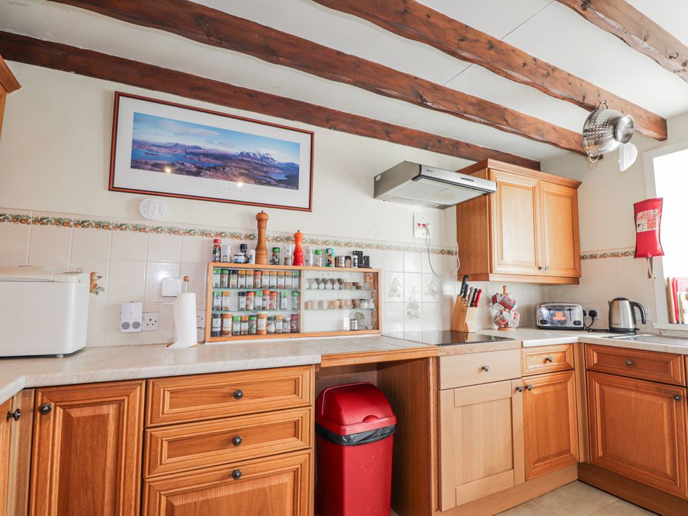A kitchen with cabinets and a countertop at An Grianan in Kinlochbervie