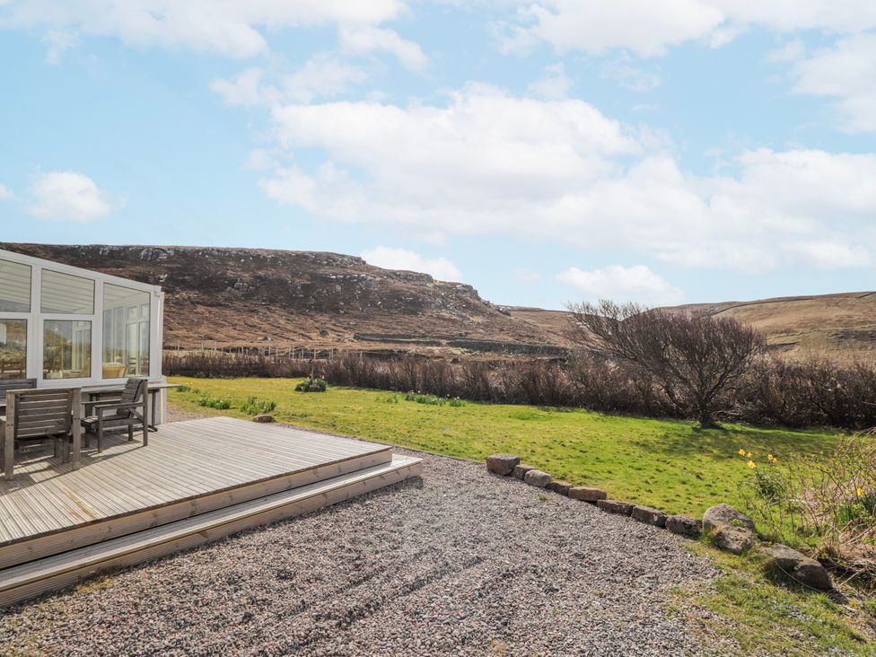 A patio area with a table and chairs at An Grianan in Kinlochbervie