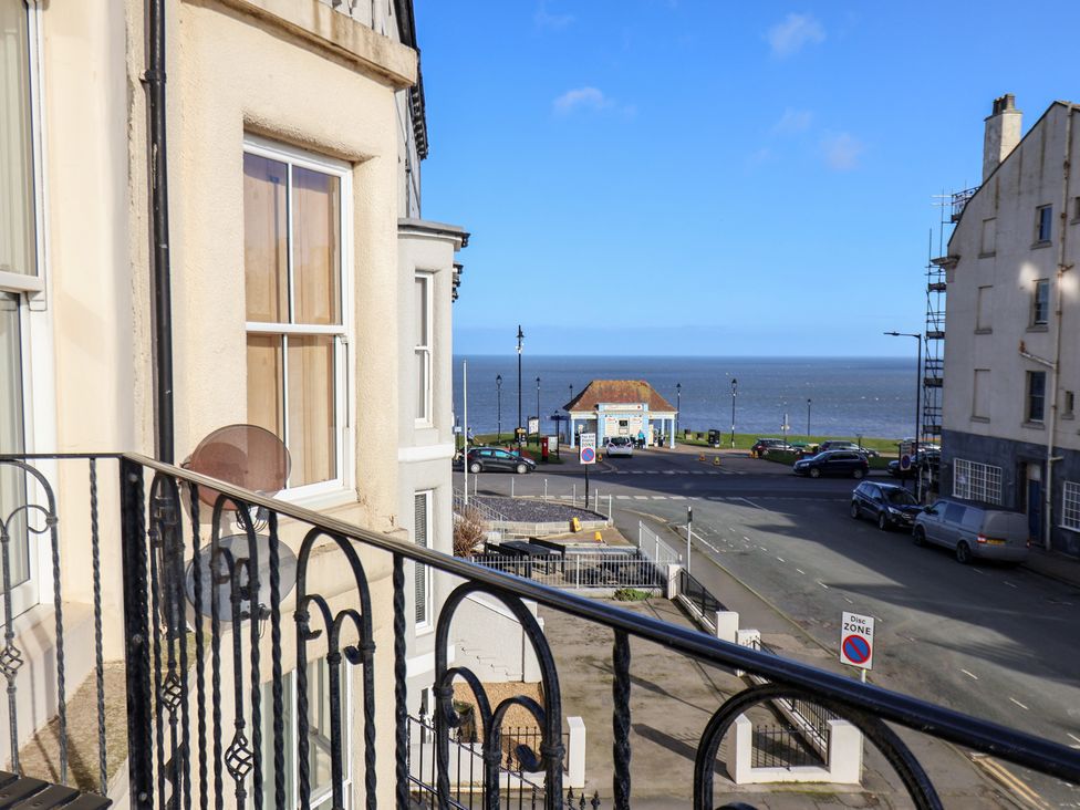 A balcony view of the ocean and street at Masons Place in Whitby