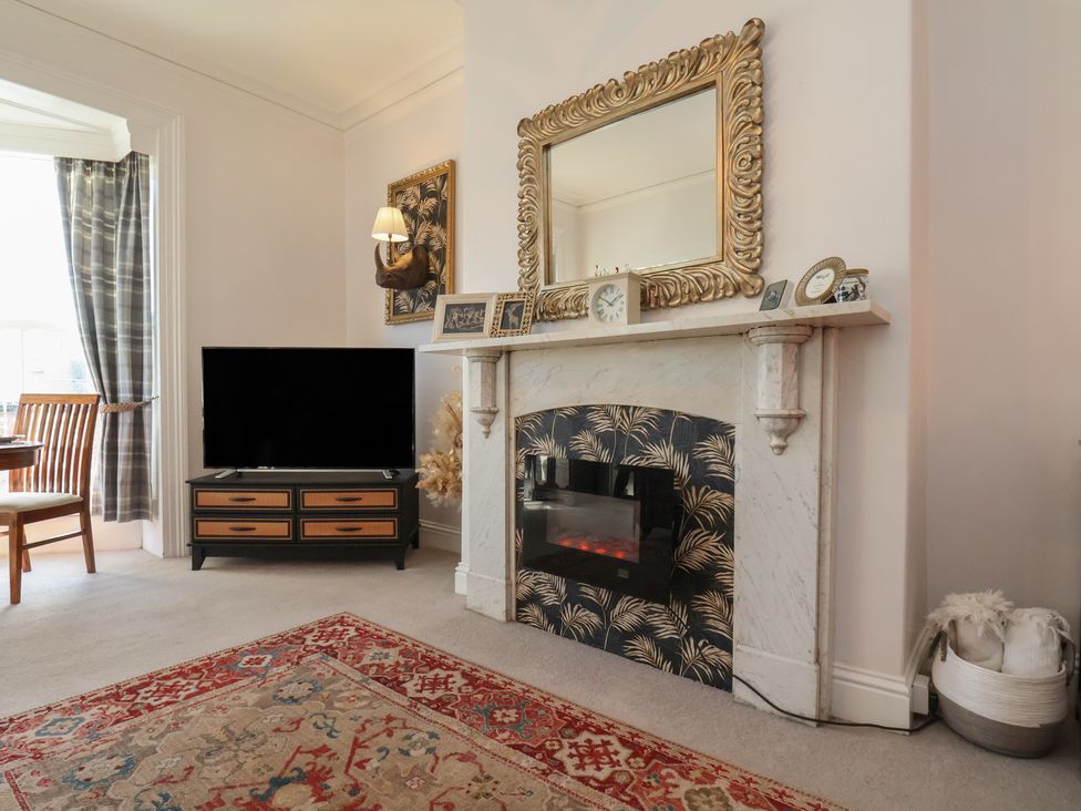 A living room with a television and fireplace at Masons Place, Whitby